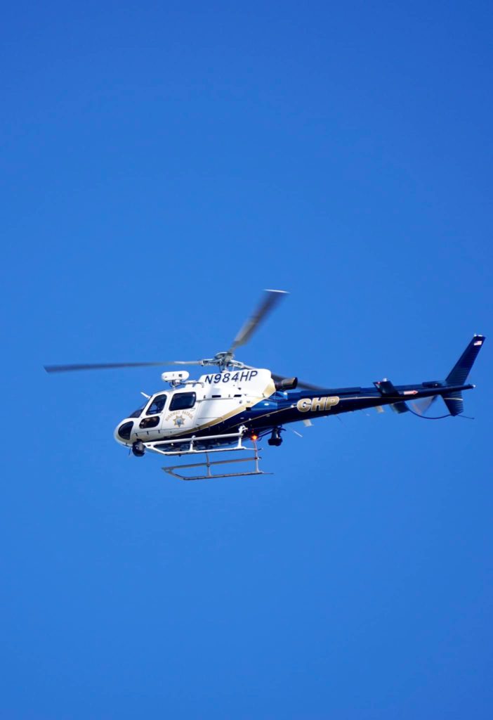 A CHP helicopter circles the picket line